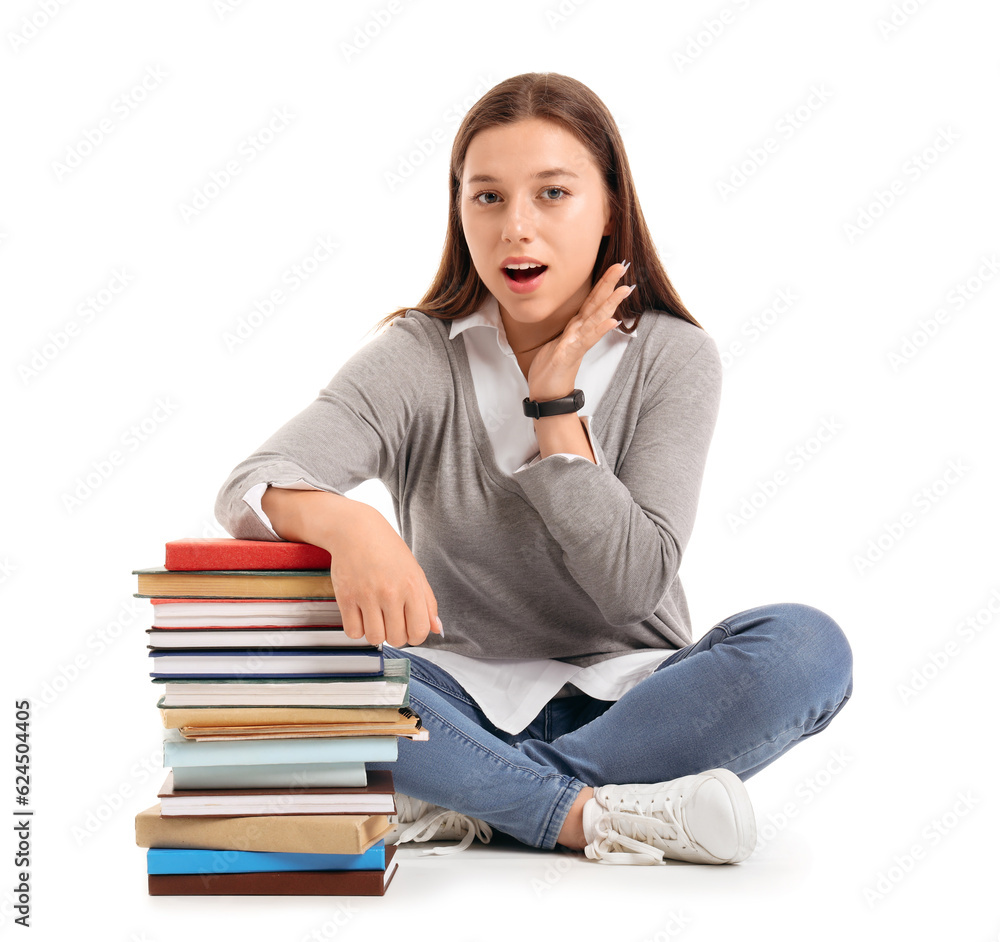 Female student with books sitting on white background