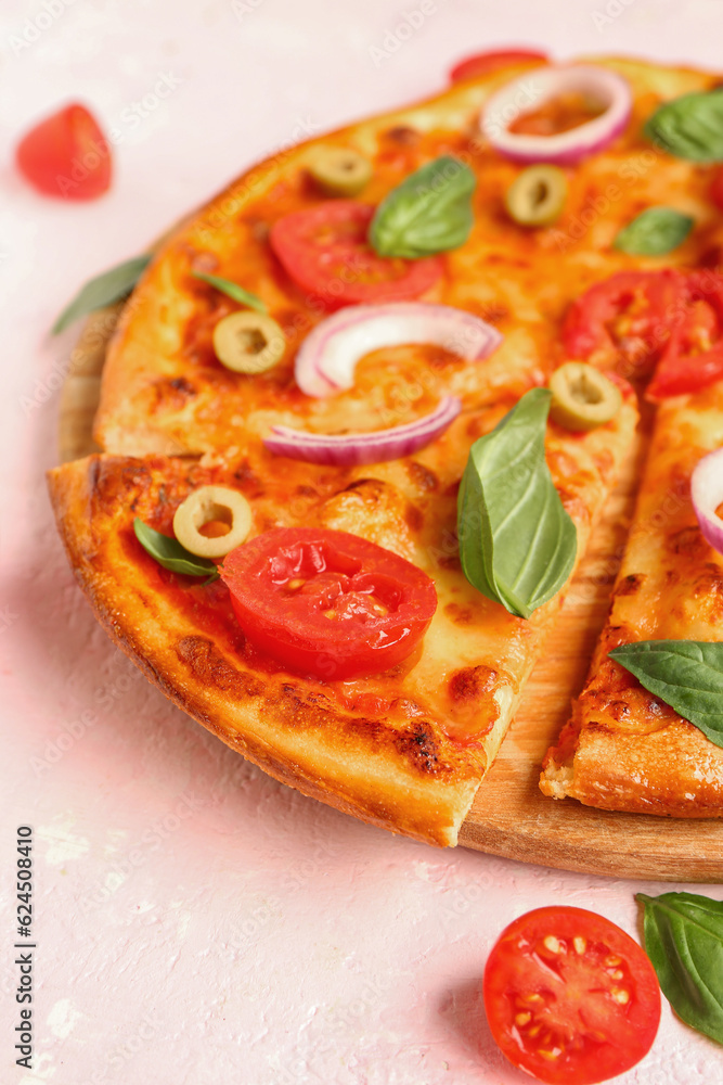 Board with tasty pizza, olives and basil on pink background