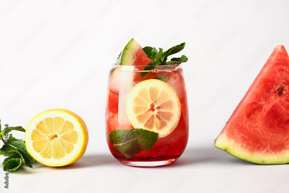 Glass of fresh watermelon lemonade with mint on white background