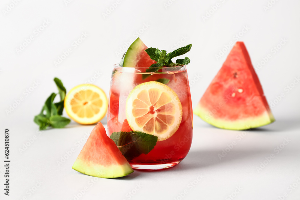 Glass of fresh watermelon lemonade with mint on white background