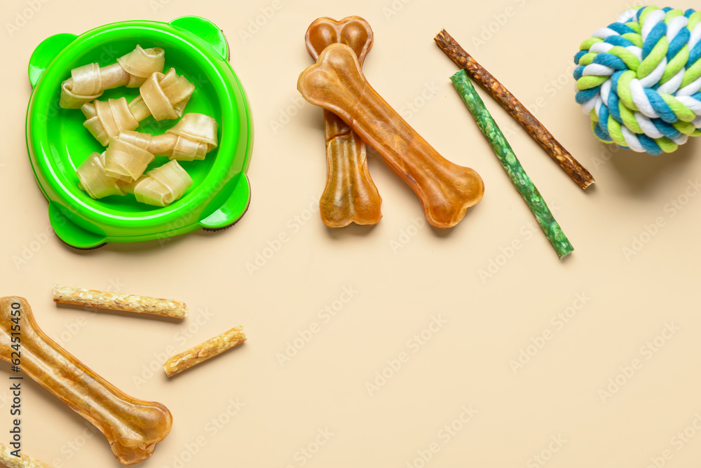 Composition with different dog treats and toy ball on color background