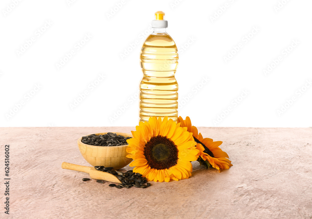 Bottle of sunflower oil on table against white background