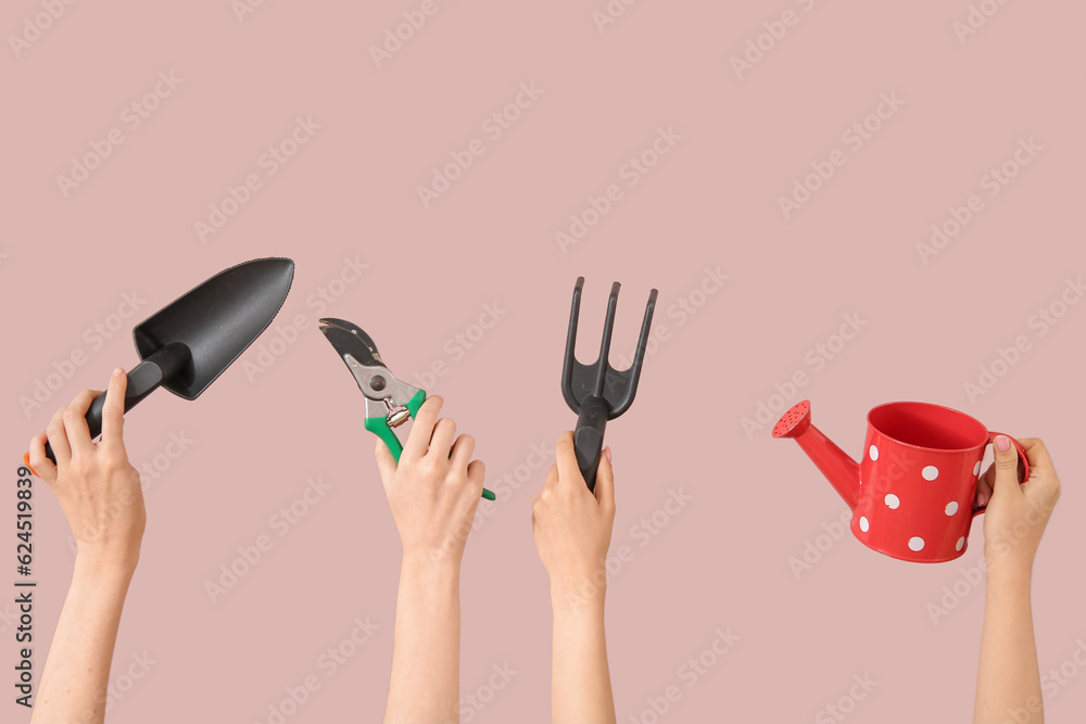 Women with different gardening tools on pink background