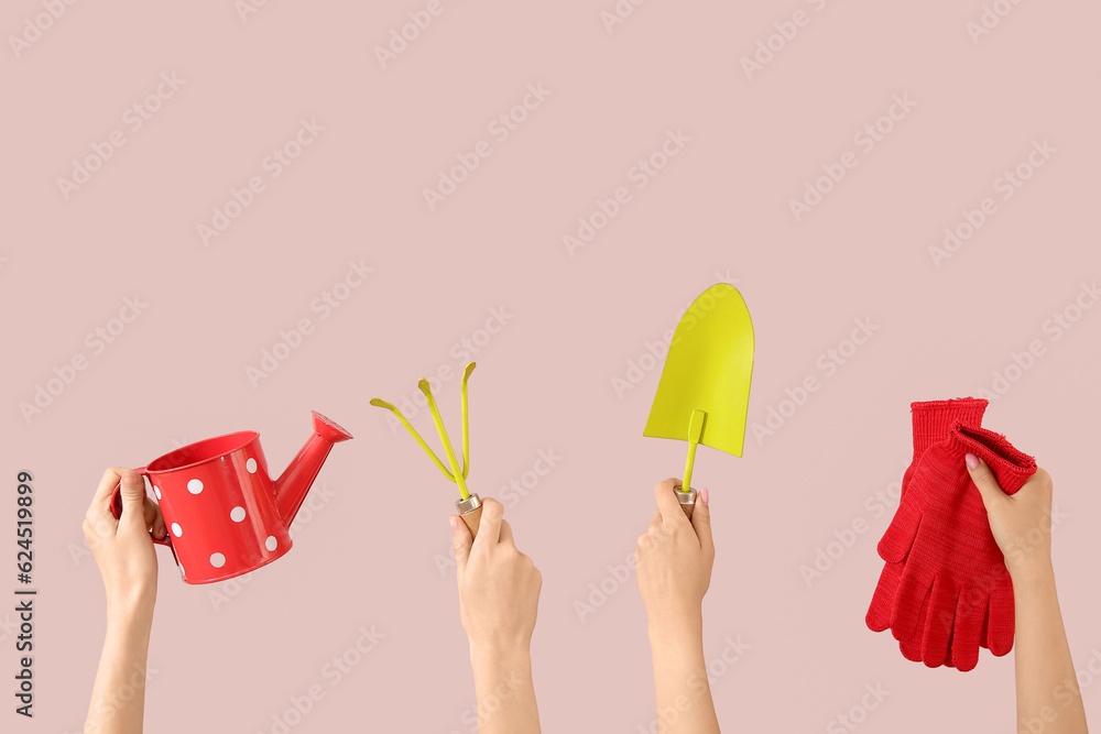 Women with different gardening tools on pink background