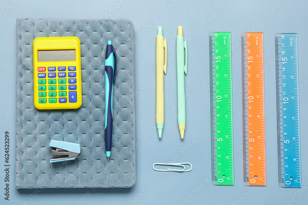 Different school stationery on grey background