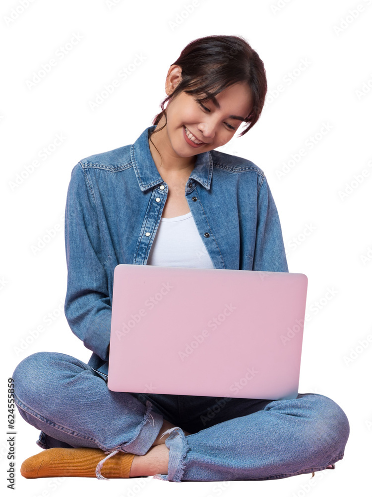 Young Asian college student sits cross-legged on floor working with a laptop computer, looking direc