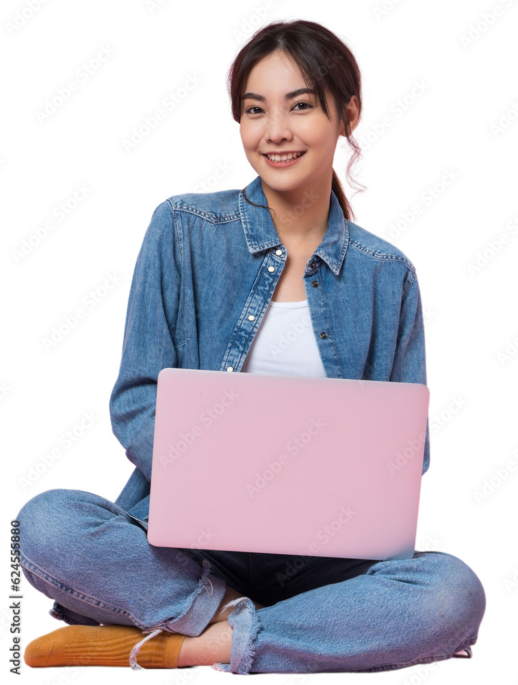 Young Asian college student sits cross-legged on floor working with a laptop computer, looking direc