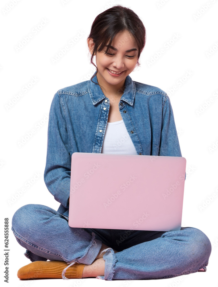 Young Asian college student sits cross-legged on floor working with a laptop computer, looking direc