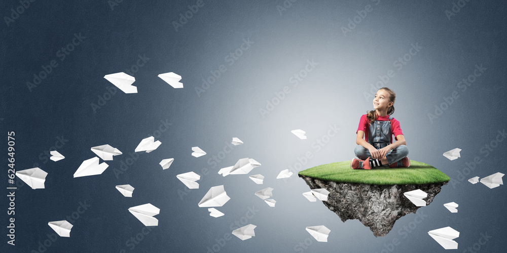 Concept of careless happy childhood with girl and paper planes flying around