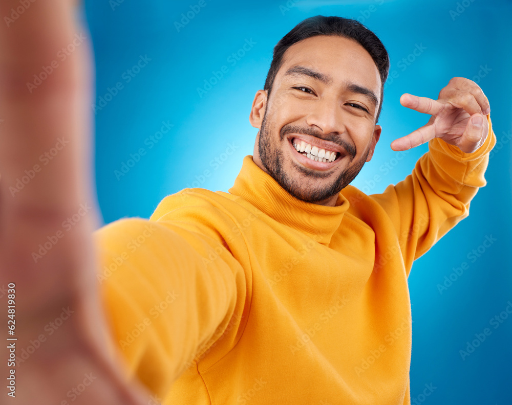 Selfie, happy and peace sign portrait of a man in studio with hand, emoji and a smile. Male asian fa