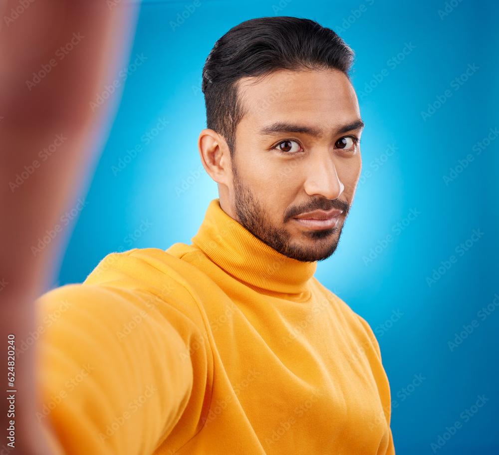 Selfie, face and portrait of a young man in studio with hand, style and fashion clothes. Serious mal