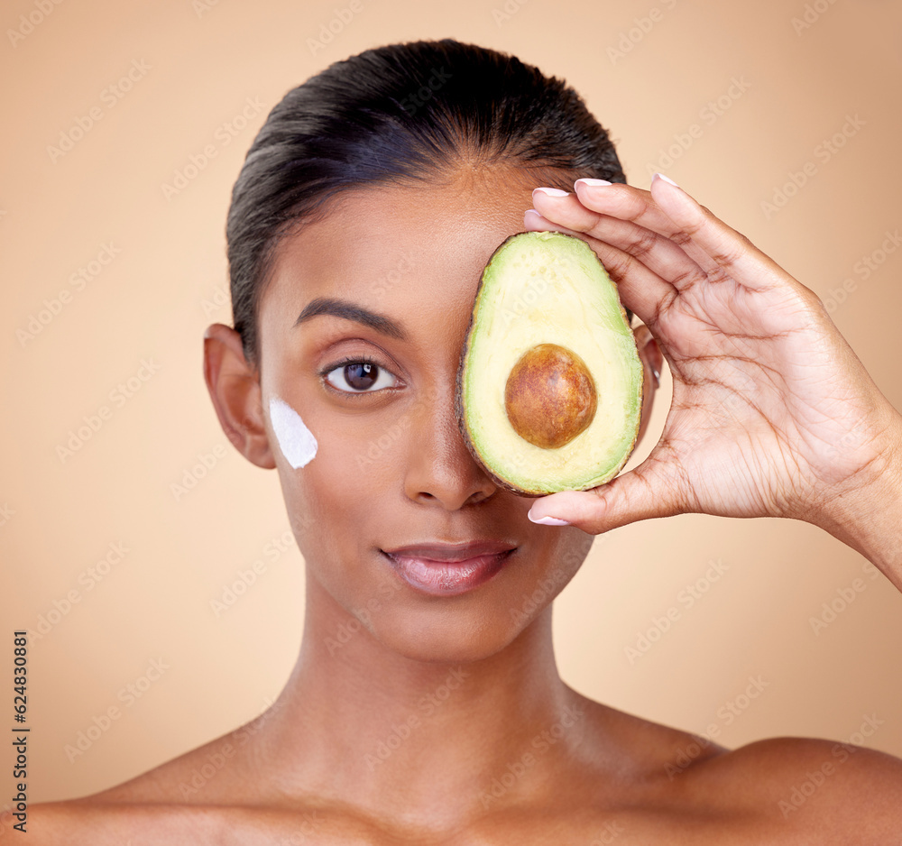 Woman, avocado and cream for face skincare, natural beauty or vitamin c benefits on studio, brown ba