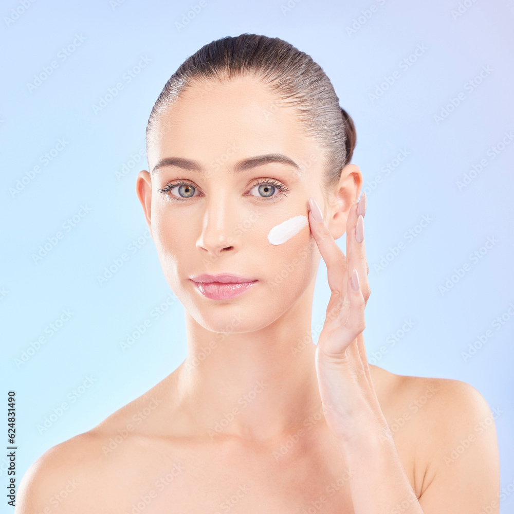 Face, skincare and woman with cream in studio isolated on a blue background. Portrait, dermatology a