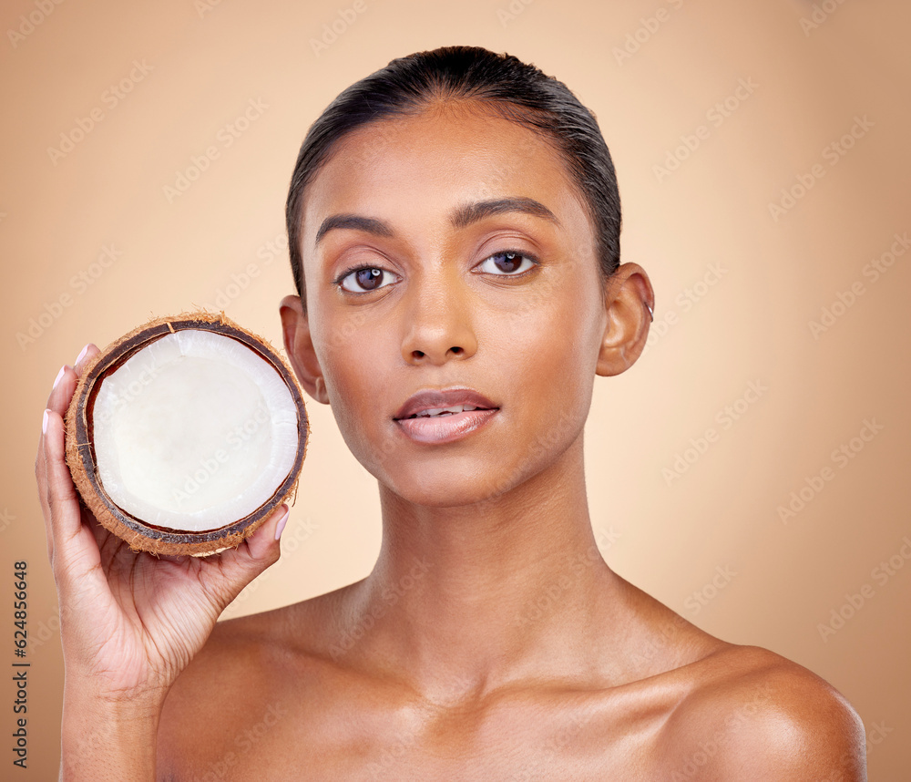 Woman face, coconut fruit and beauty, healthy skincare or vegan cream on brown studio background. Po