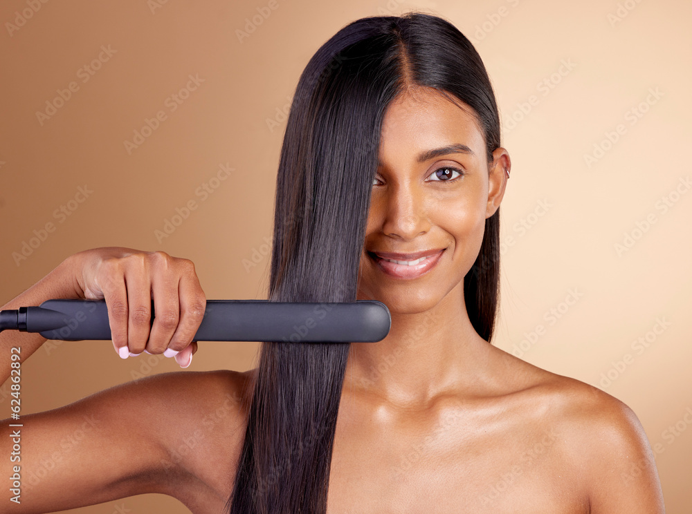 Portrait, hair and straightener with a model woman in studio on a beige background for beauty or sty