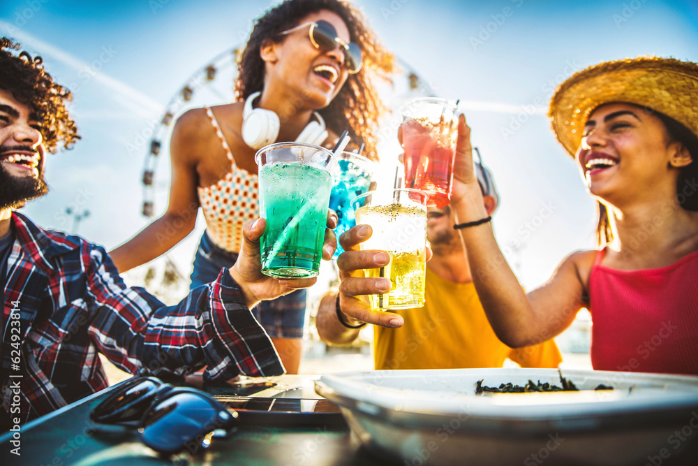 Multiracial happy friends toasting cocktail glasses outdoors at summer vacation - Smiling young peop