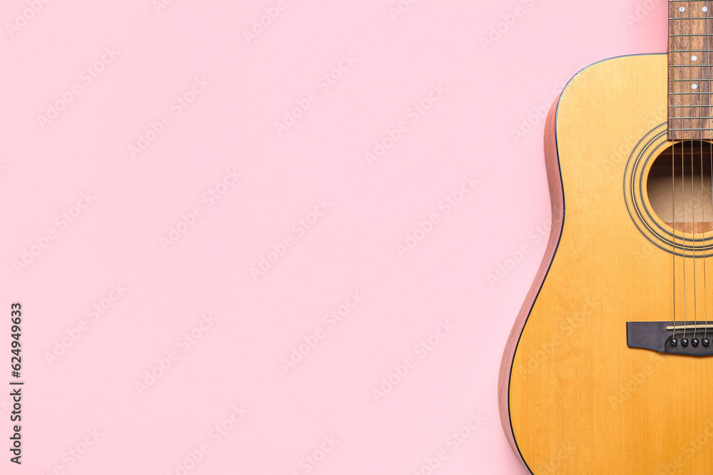 Acoustic guitar on color background