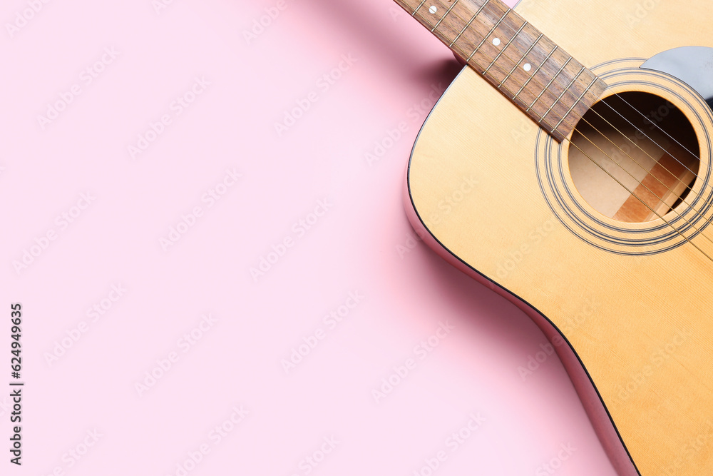 Acoustic guitar on color background