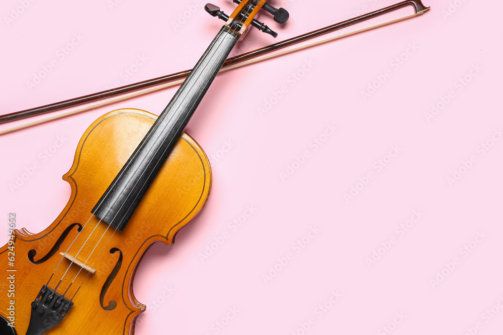 Beautiful violin with bow on color background