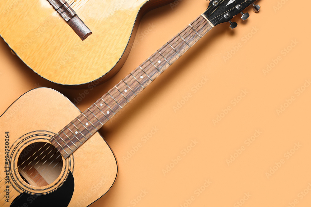 Acoustic guitars on color background, top view