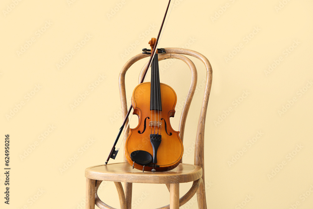 Chair with violin near color wall