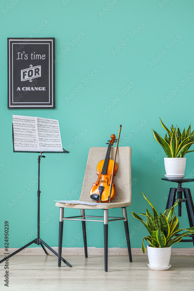 Chair with violin and note stand in room