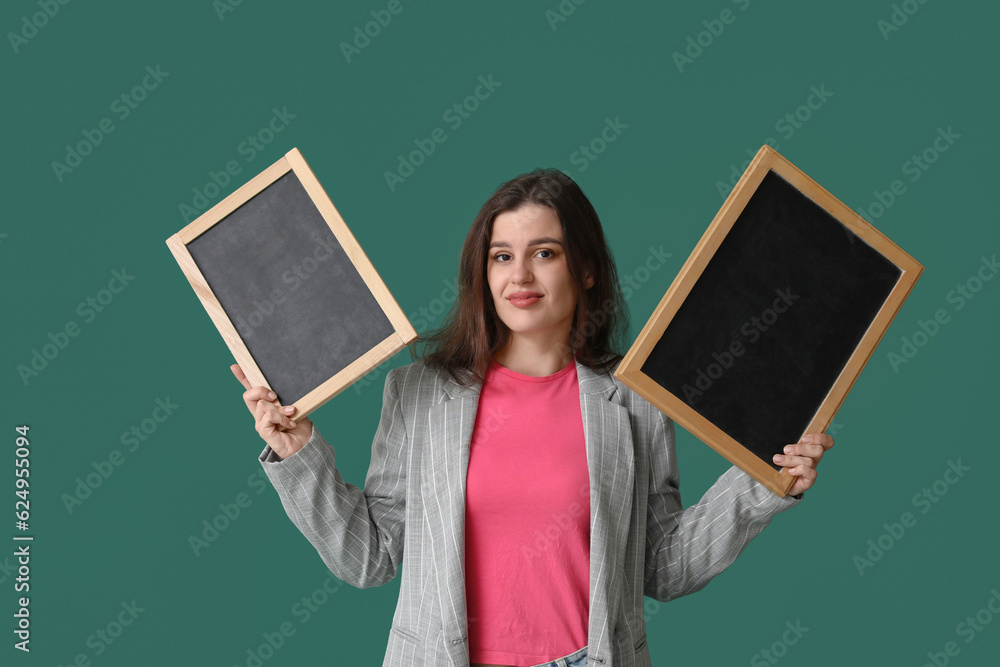 Female teacher with chalkboards on green background