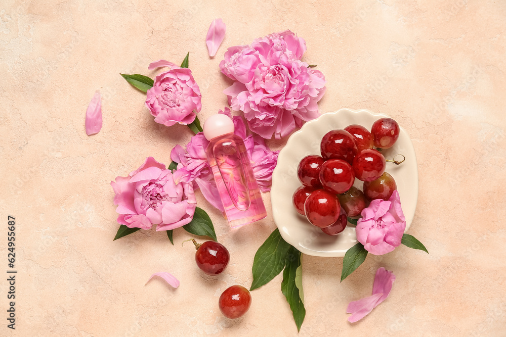 Composition with bottle of essential oil, grapes and peony flowers on color background