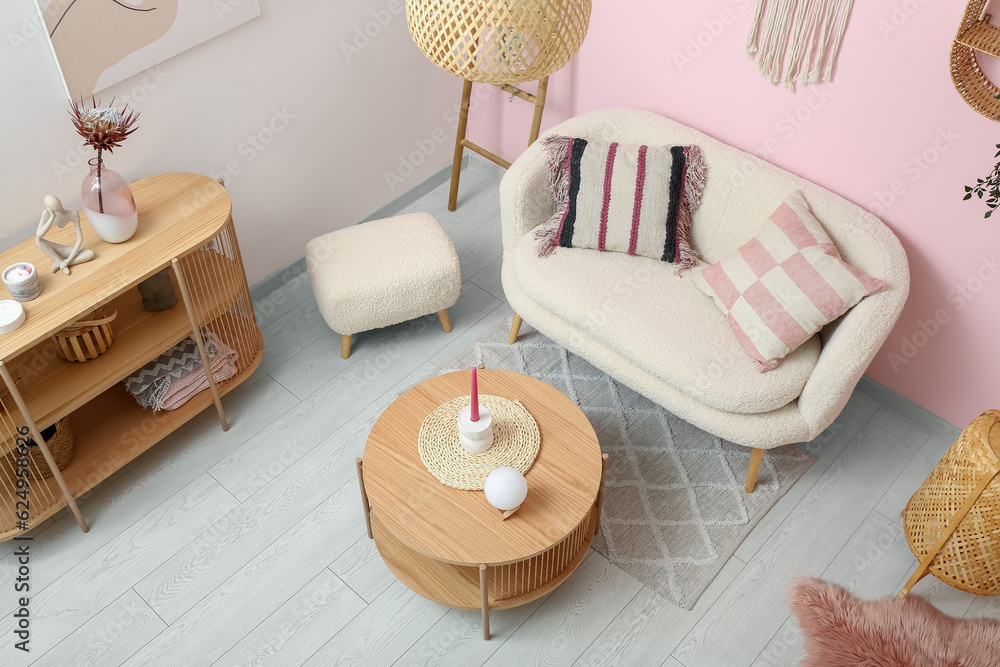 Living room interior with white sofa, coffee table and ottoman