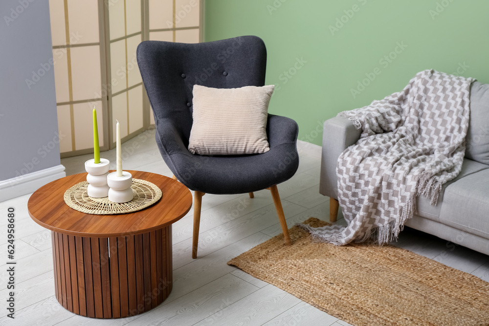 Modern living room interior with grey sofa, armchair and coffee table