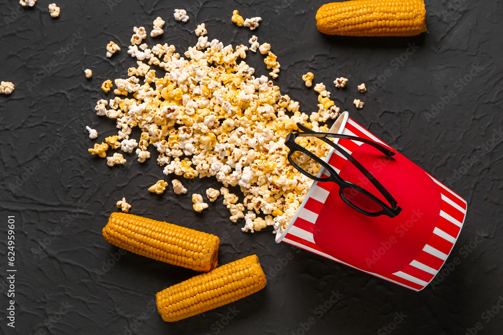 Bucket with tasty popcorn and 3D glasses on black background