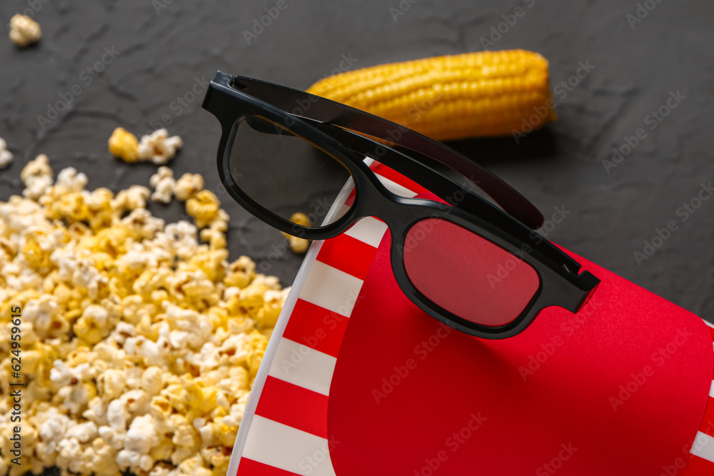 Bucket with tasty popcorn and 3D glasses on black background