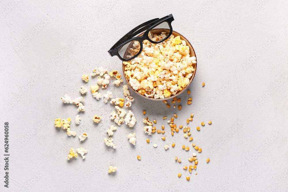 Bowl with tasty popcorn and 3D glasses on grey background