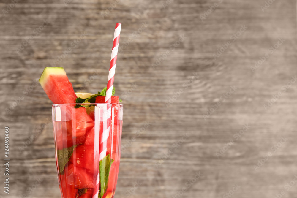 Glass of fresh watermelon lemonade with mint on wooden background