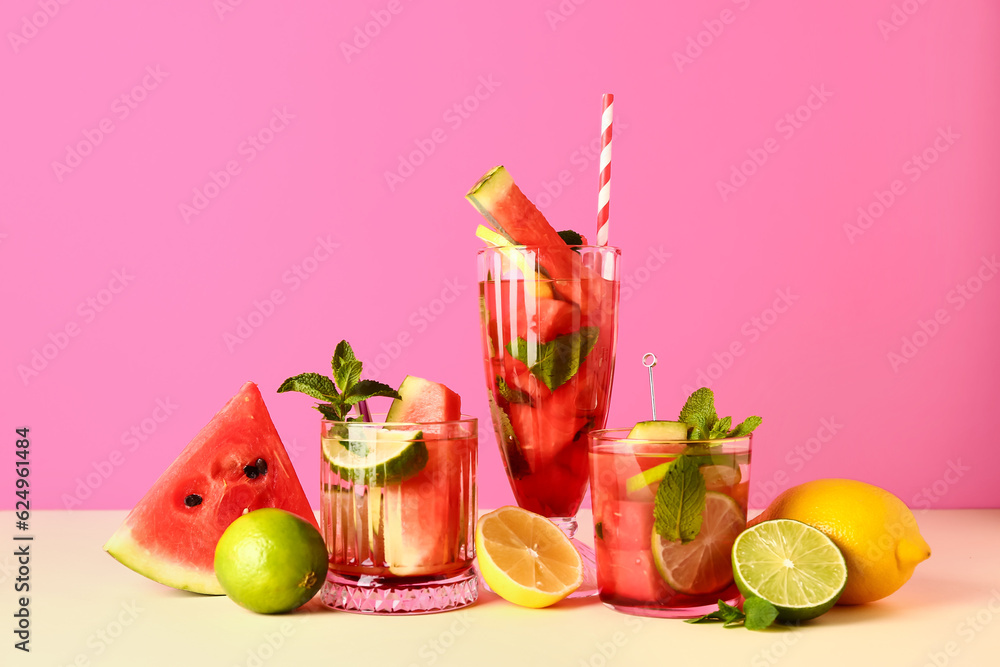 Glasses of fresh watermelon lemonade with lime and mint on yellow table