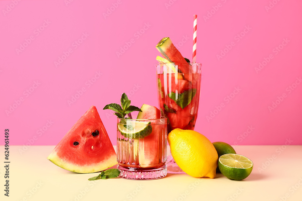 Glasses of fresh watermelon lemonade with lime and mint on yellow table