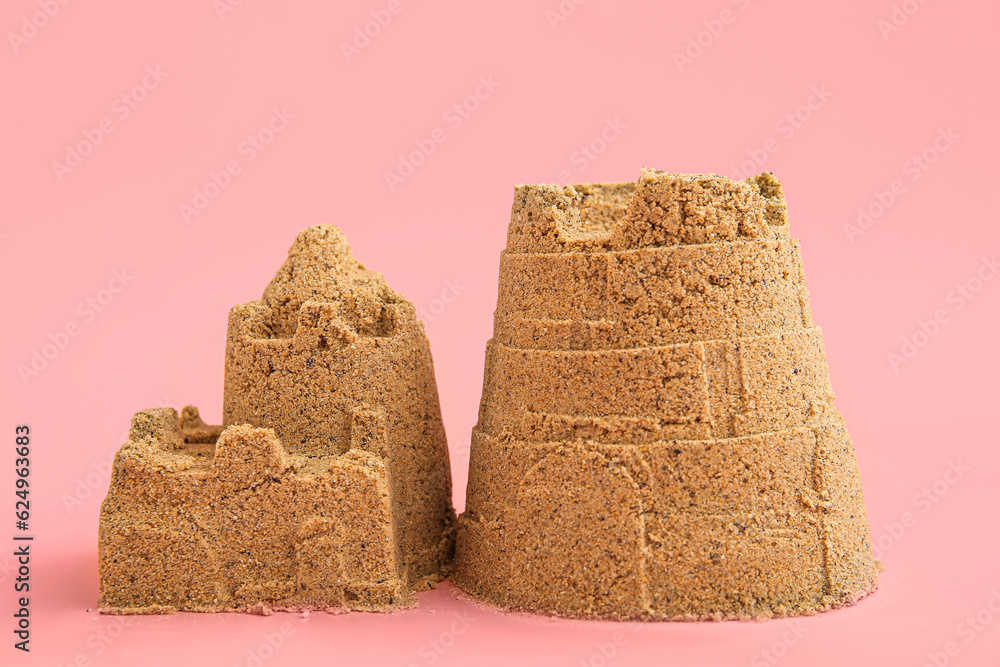 Castle made of sand on pink background