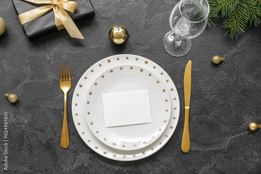 Beautiful table setting for Christmas celebration on black background