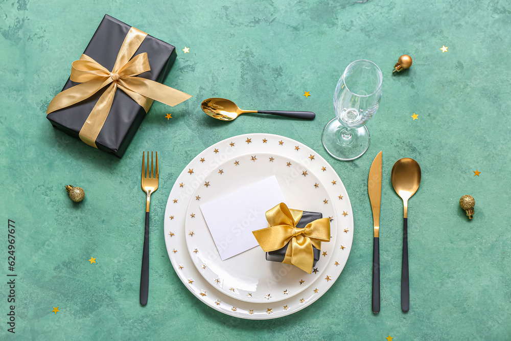 Beautiful table setting for Christmas celebration on green background