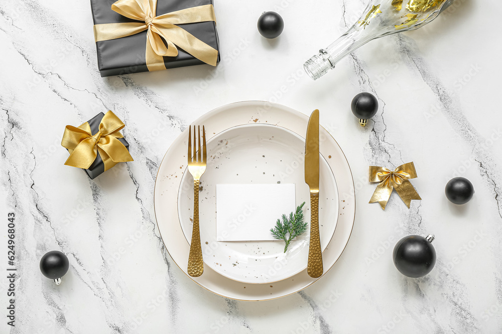 Beautiful table setting for Christmas celebration on white marble background