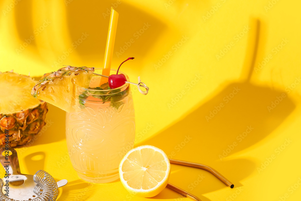 Glass of tasty mai tai cocktail on yellow background