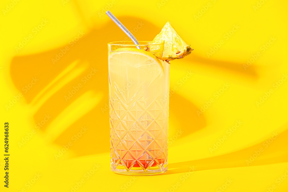 Glass of tasty mai tai cocktail on yellow background