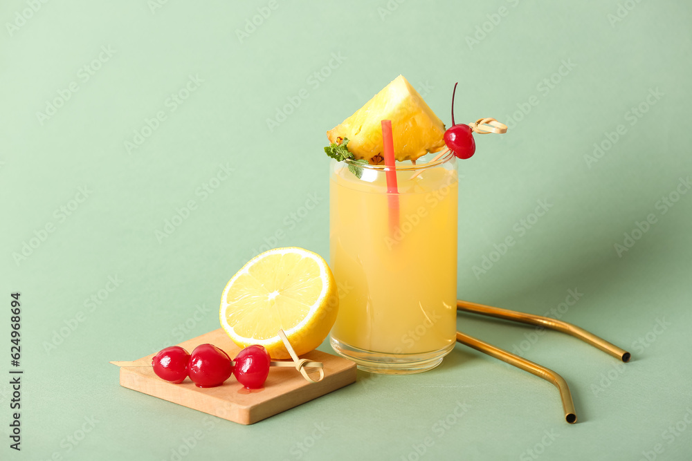 Glass of tasty mai tai cocktail on green background