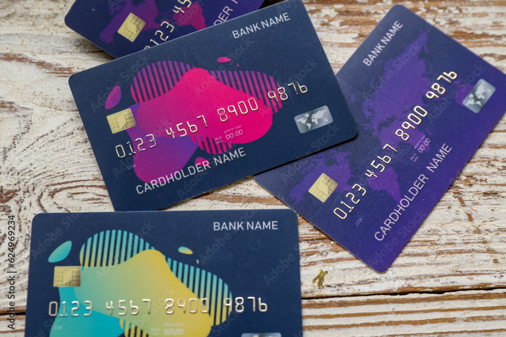 Many credit cards on light wooden background