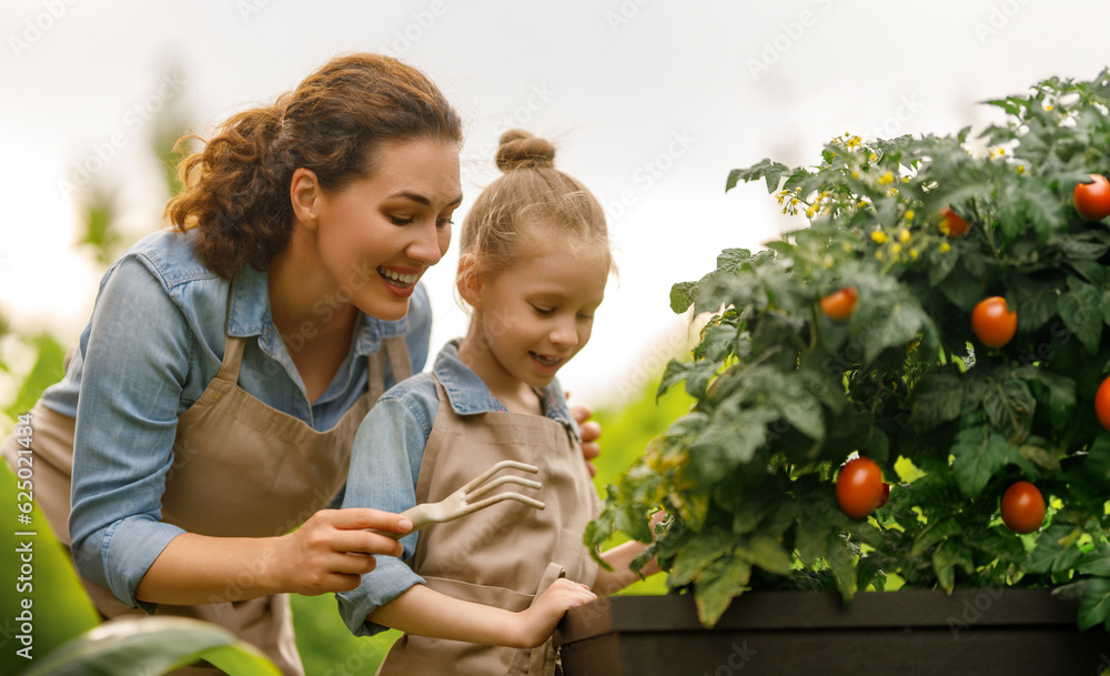 mother and daughter gardening in the backyard