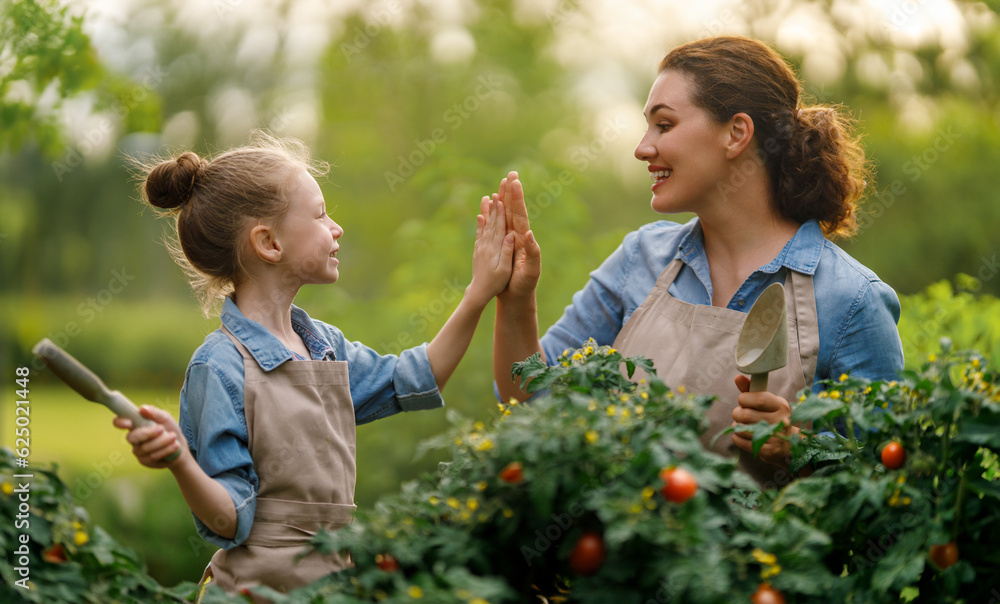 mother and daughter gardening in the backyard