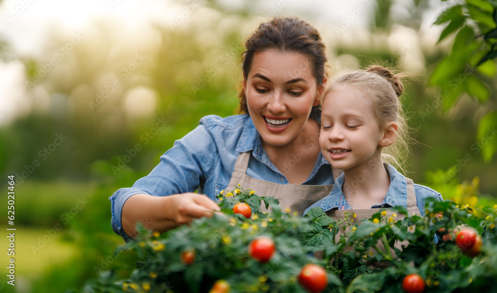 mother and daughter gardening in the backyard