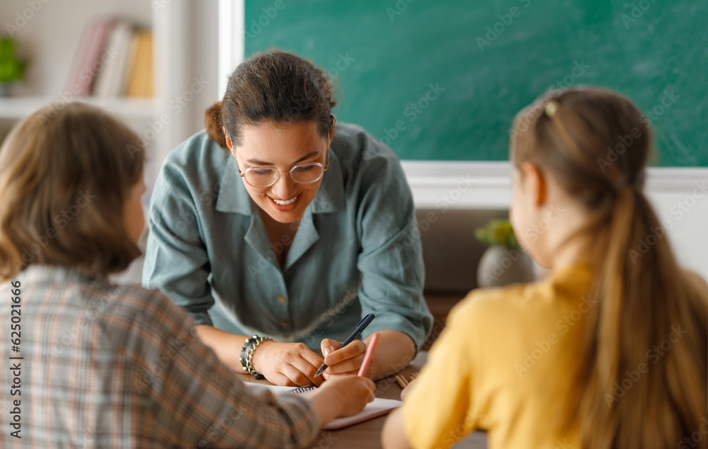 Happy kids and teacher at school