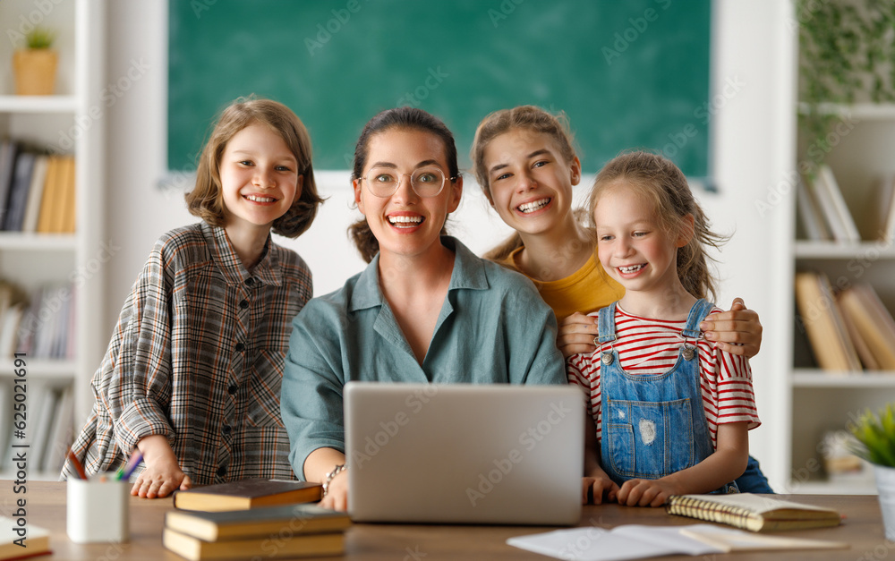 Happy kids and teacher at school