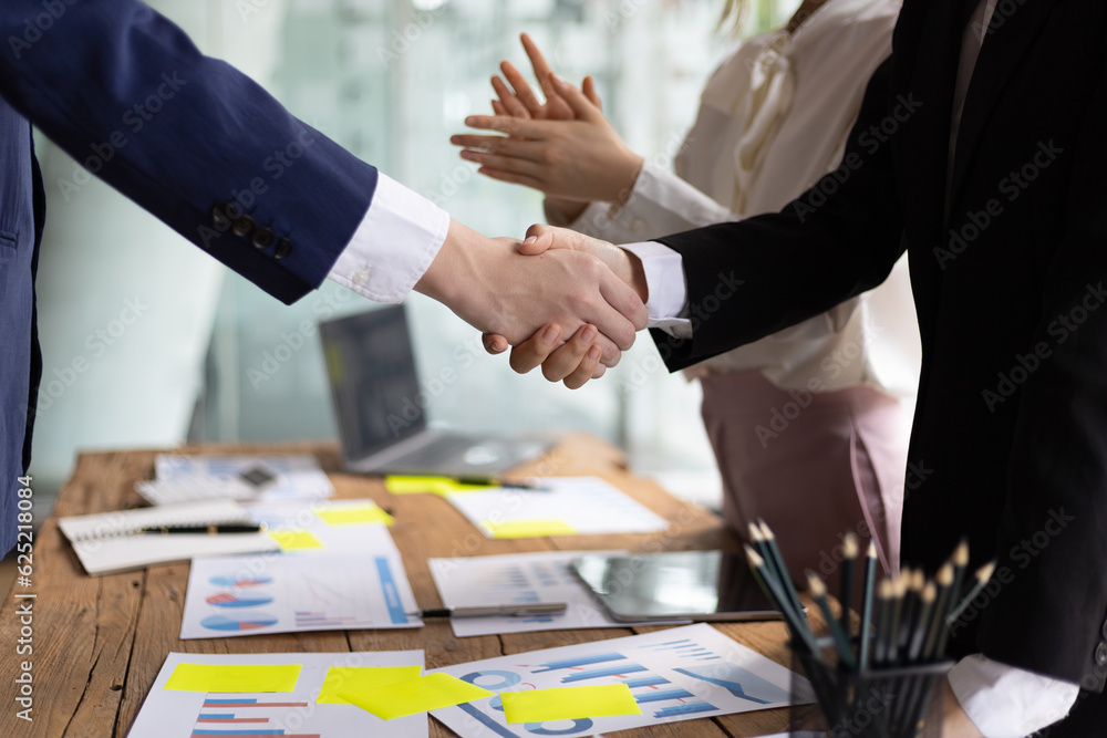 Business meeting, businesswomen shaking hands in business partnership meeting.